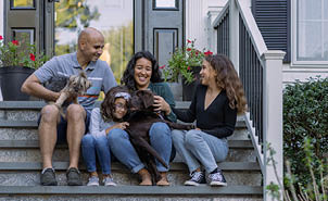family on porch with puppy